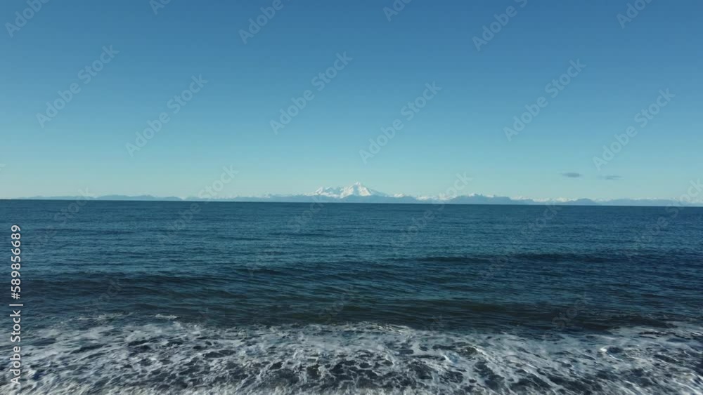 Scenic view of a tranquil sea against a blue sky captured from the rocky shore Scenic view of a tranquil sea against a blue sky captured from the rocky shore