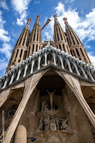 Vertical of a detail of the Cathedral of Barcelona designed by Gaudi against cloudy sky