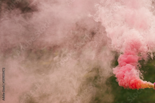 Pink smoke from a smoke bomb in nature