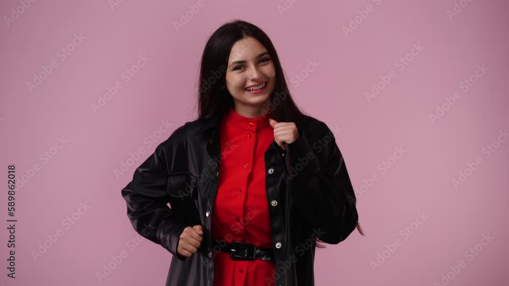 4k video of one girl smiling and dancing over pink background. 4k video of one girl smiling and dancing over pink background.