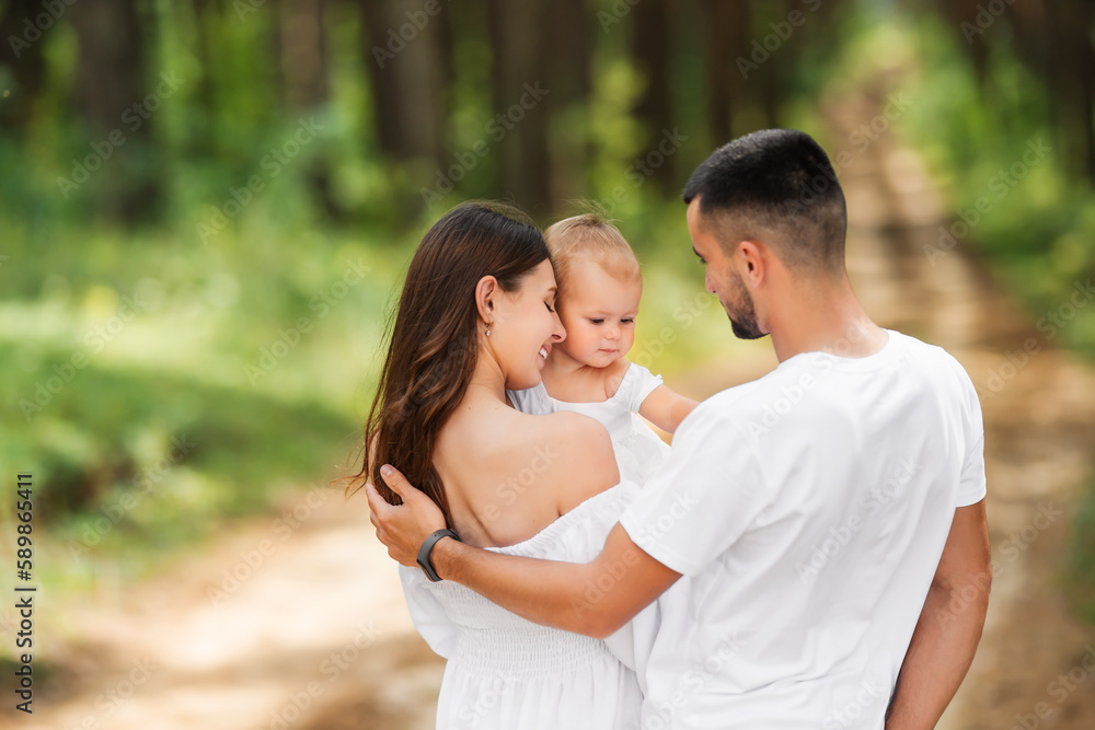 Mom, dad and daughter on summer walk. Happy family resting in nature. Mom, dad and daughter on summer walk. Happy family resting in nature.