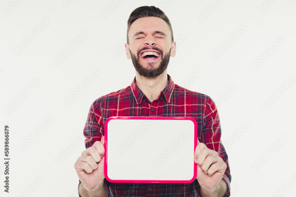 Happy young bearded man showing and displaying white empty placard ready for your text or product or ad Happy young bearded man showing and displaying white empty placard ready for your text or product or ad