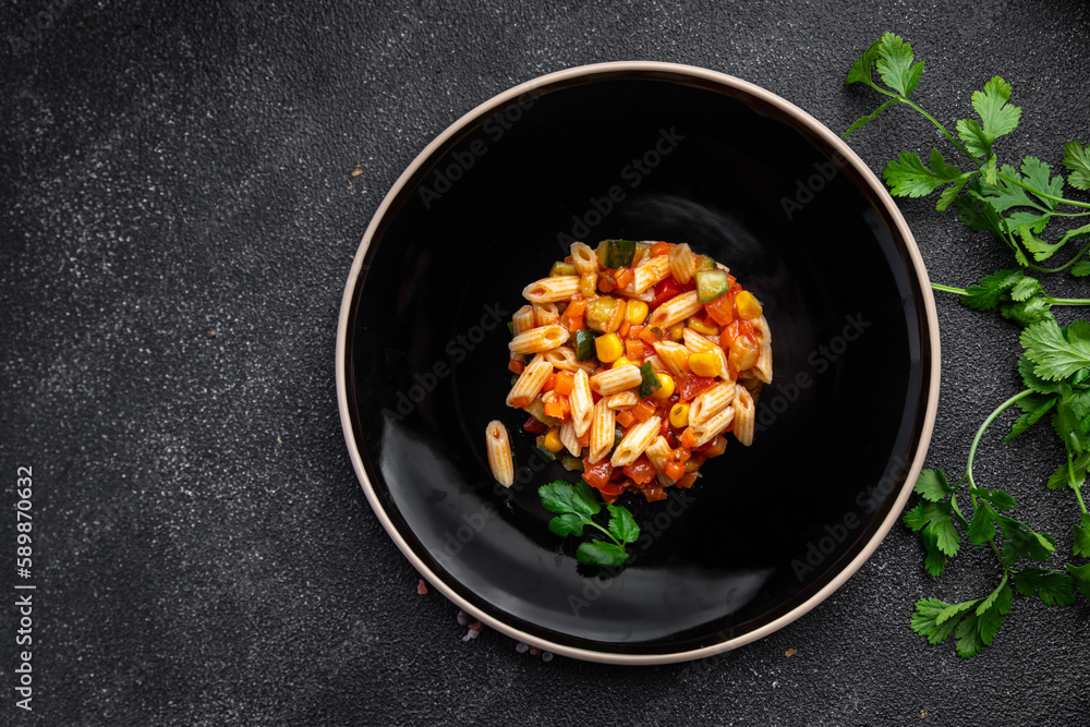 pasta salad tomato, cucumber, corn, fresh vegetable, penne pasta meal food snack on the table copy space food background rustic top view 