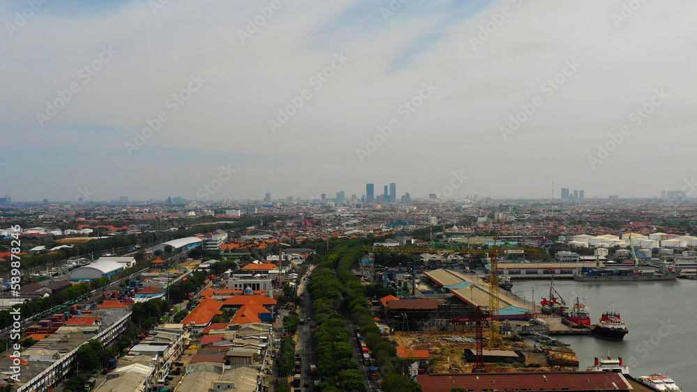 Aerial cityscape densely built asian city, seaport. urban environment in asia. modern city Surabaya with buildings and houses. Surabaya capital city east java, indonesia