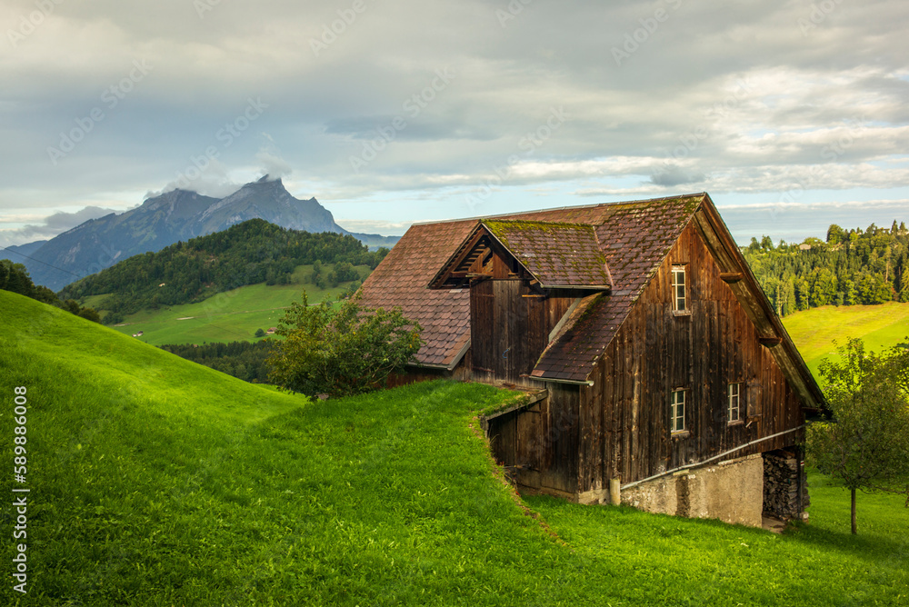 Green hills and farm buildings near the Buergenstock in the countryside of Lucerne in Switzerland
