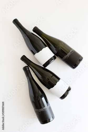 four bottles of wine with blank labels on a white background