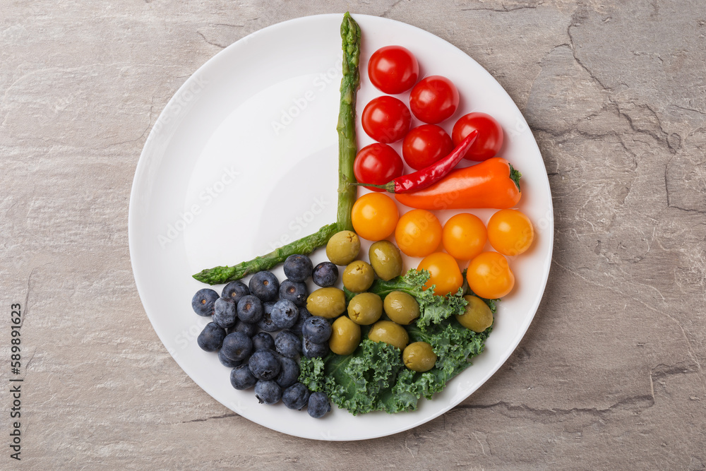 Interval fasting diet concept represented with a plate and products on dark stone table. Organic meal. Weight loss concept. Healthy eating. Interval fasting diet concept represented with a plate and products on dark stone table. Organic meal. Weight loss concept. Healthy eating.