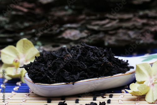 A handful of black tea on a ceramic spoon