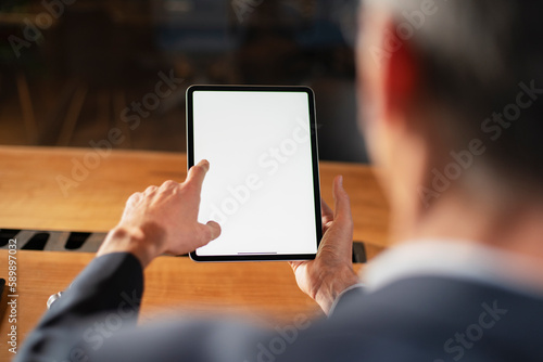 Close up of man using digital tablet..