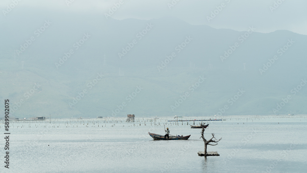 Fisherman in a boat on the river background