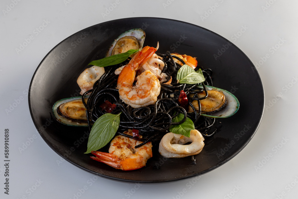 Spicy Seafood Squid Ink Spaghetti on white background Spicy Seafood Squid Ink Spaghetti on white background