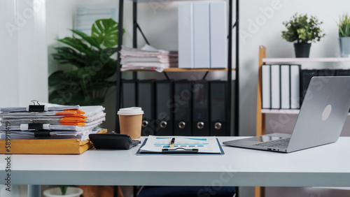 Stylish workspace with laptop, notebook, blank screen laptop on white table of bookkeeping.