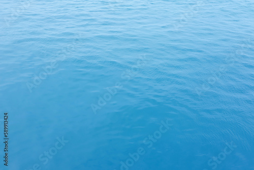 Blue Sea surface aerial view with waves from a drone, empty blank to background. soft focus.