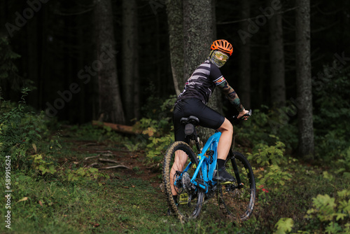 Mountain biker riding on bike in autumn inspirational mountains landscape banner. Man cycling MTB on enduro trail track. Sport fitness motivation and inspiration.