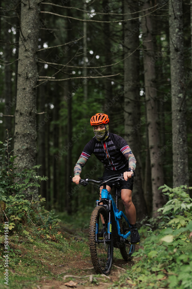 A cyclist rides a bicycle. Down the hill. A cyclist rides a bicycle. Down the hill.