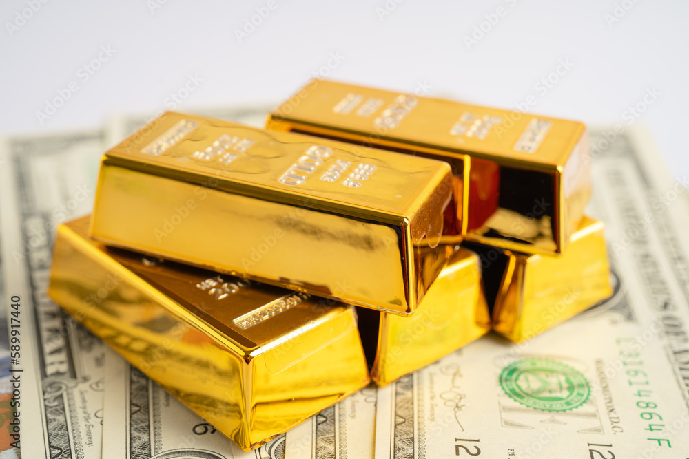 Gold bar on US dollar banknotes money, economy finance exchange trade investment concept. Gold bar on US dollar banknotes money, economy finance exchange trade investment concept.