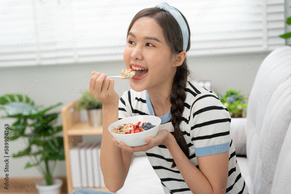 healthy food. Beautiful female girl enjoy eat yogurt, granola, fresh fruits on breakfast health in house. Happy young woman smile on morning good emotion. dieting, detox, diet, clean eat, vegetarian healthy food. Beautiful female girl enjoy eat yogurt, granola, fresh fruits on breakfast health in house. Happy young woman smile on morning good emotion. dieting, detox, diet, clean eat, vegetarian