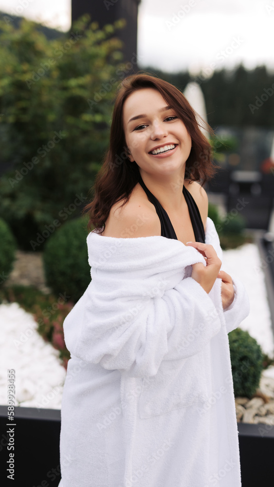 A beautiful girl in a swimsuit rests on the background of the pool. A beautiful girl in a swimsuit rests on the background of the pool.