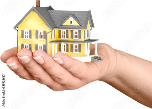 Women's Hand Holding a Model of a House - Isolated