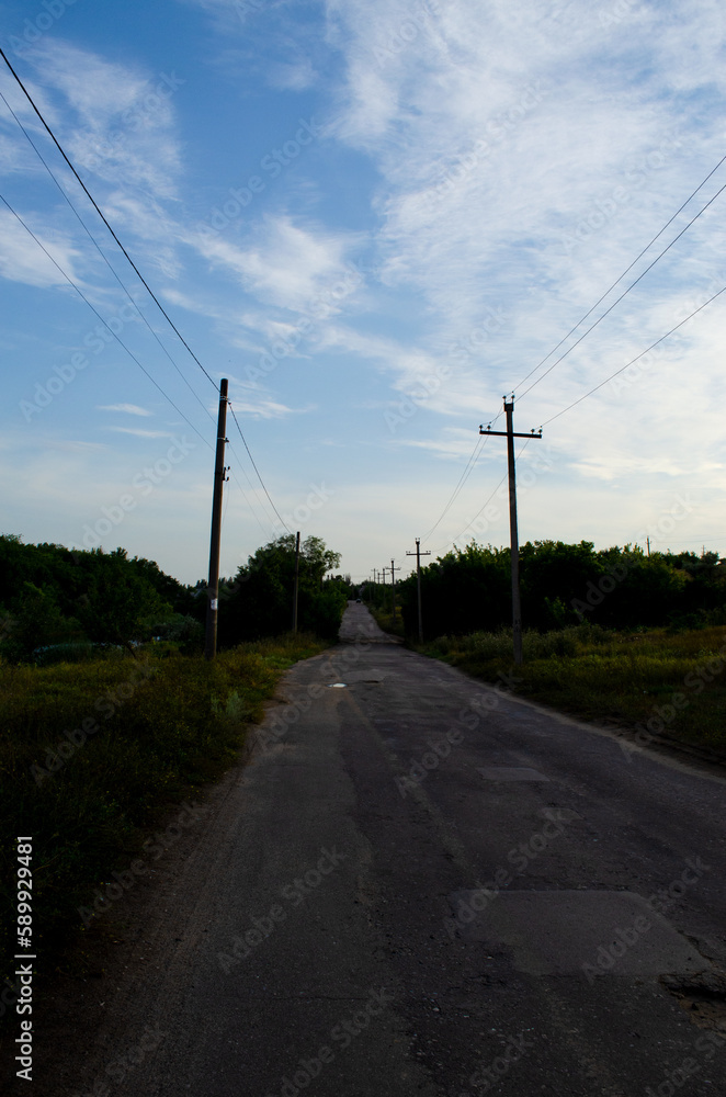Road in Ukraine in the village in the evening against the sky Road in Ukraine in the village in the evening against the sky