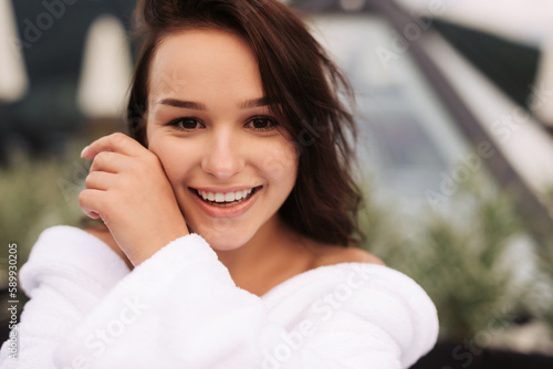 Portrait of a young smiling woman looking at the camera