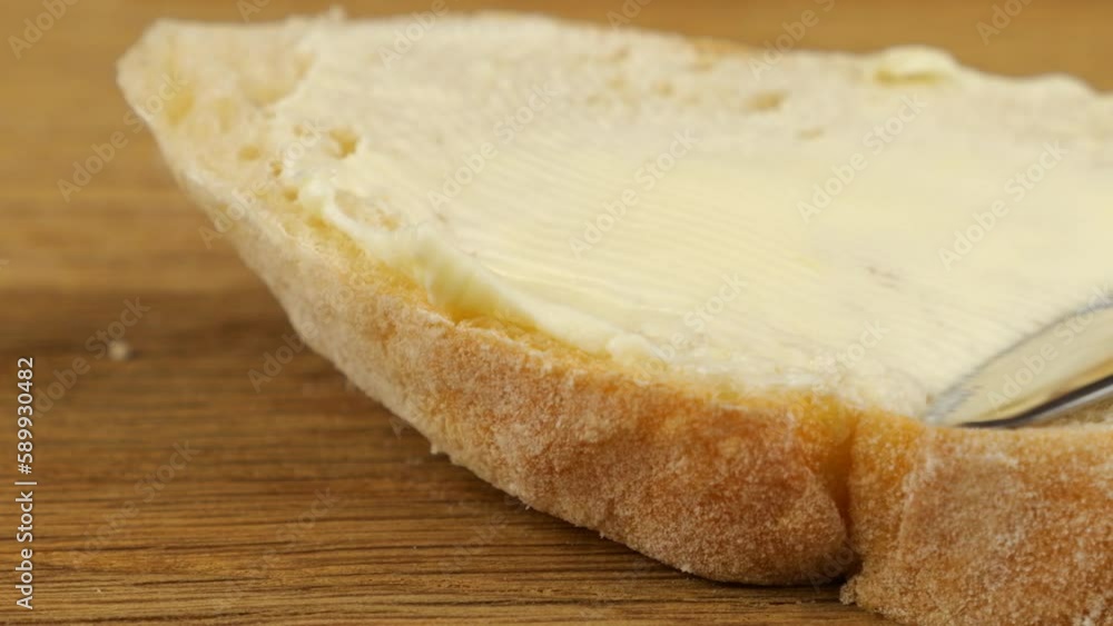 Cooking a sandwich from white bread and butter with red caviar on a wooden cutting board. Cooking a sandwich from white bread and butter with red caviar on a wooden cutting board.