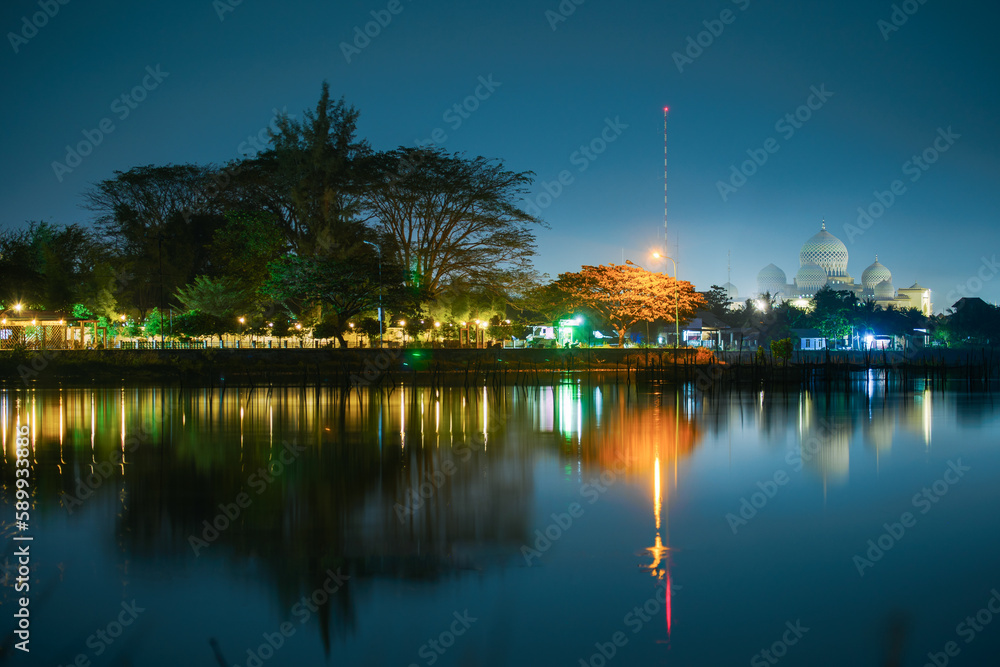 View of the dome of the Islamic Center Mosque and the reflection of the lake in Lhokseumawe, Aceh, Indonesia