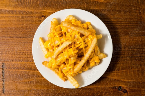 Crinkle cut fries with cheese sauce