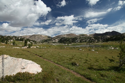 Dirt hiking trail by a subalpine lake in Beartooth Mountains, Wyoming