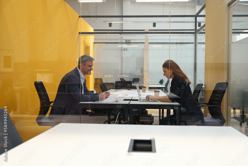 Smiling man and woman sitting in the business center Smiling man and woman sitting in the business center