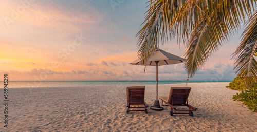 Tranquil sea sand sunset sky relaxing beach. Love couple romantic freedom travel landscape concept. Idyllic exotic chairs umbrella, palm tree leaves, tropics beachfront resort. Summer vacation island