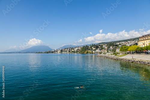 Neuchatel Lake in Switzerland seen from the port promenade of Estavayer-le-Lac, with plants and flowers on a sunny day photo