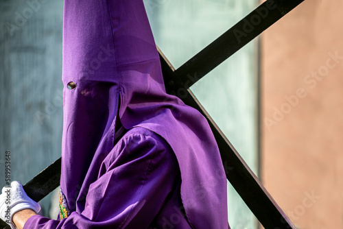 Schilderij op canvas Nazareno with the cross and the hood in the Good Friday procession of Holy Week