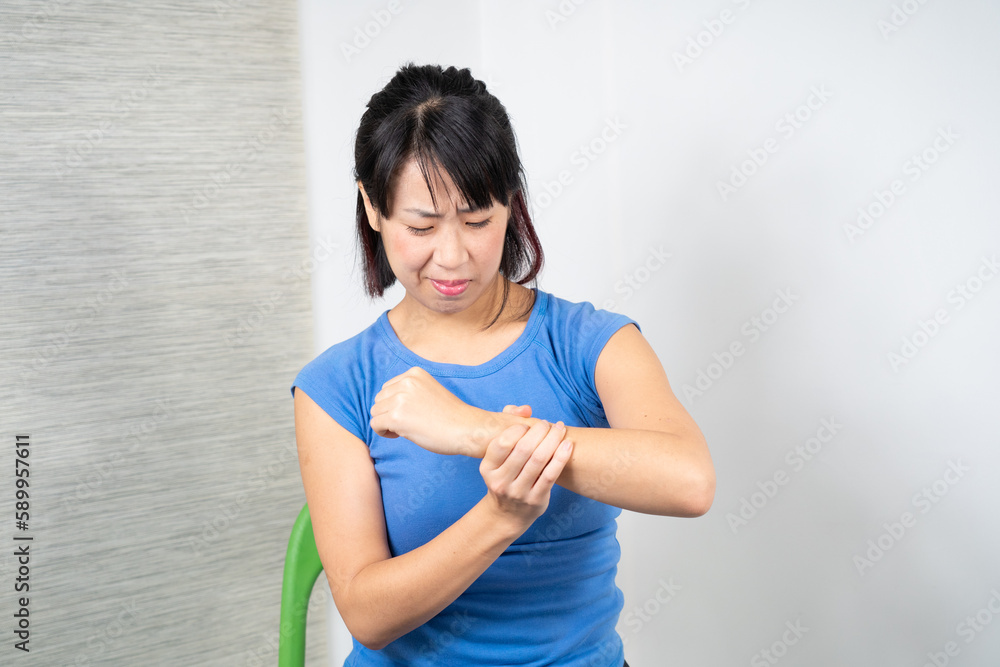Asian woman having wrist pain.