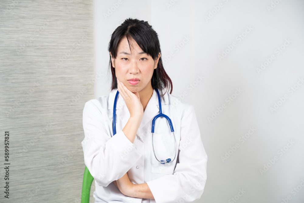Asian female doctor during a consultation. Asian female doctor during a consultation.