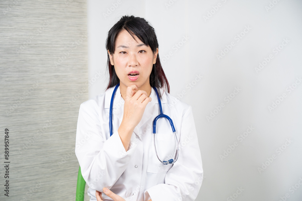 Asian female doctor during a consultation. Asian female doctor during a consultation.