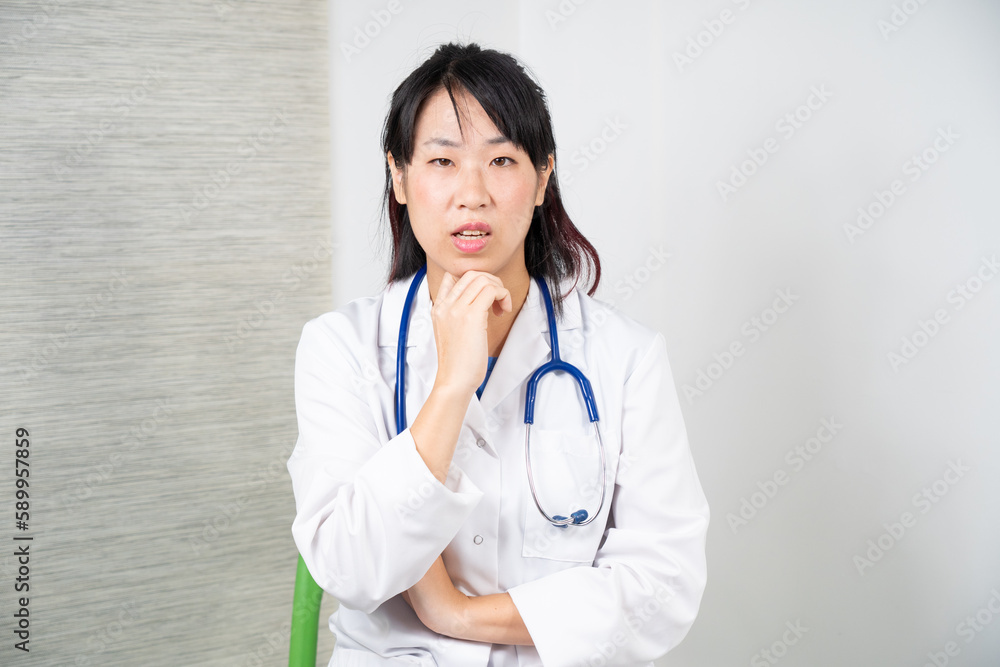 Asian female doctor during a consultation. Asian female doctor during a consultation.