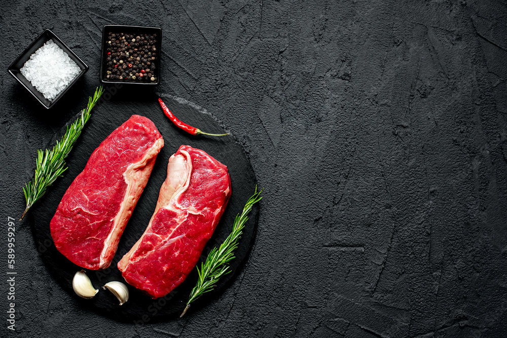 raw beef steak on stone background with copy space for your text raw beef steak on stone background with copy space for your text