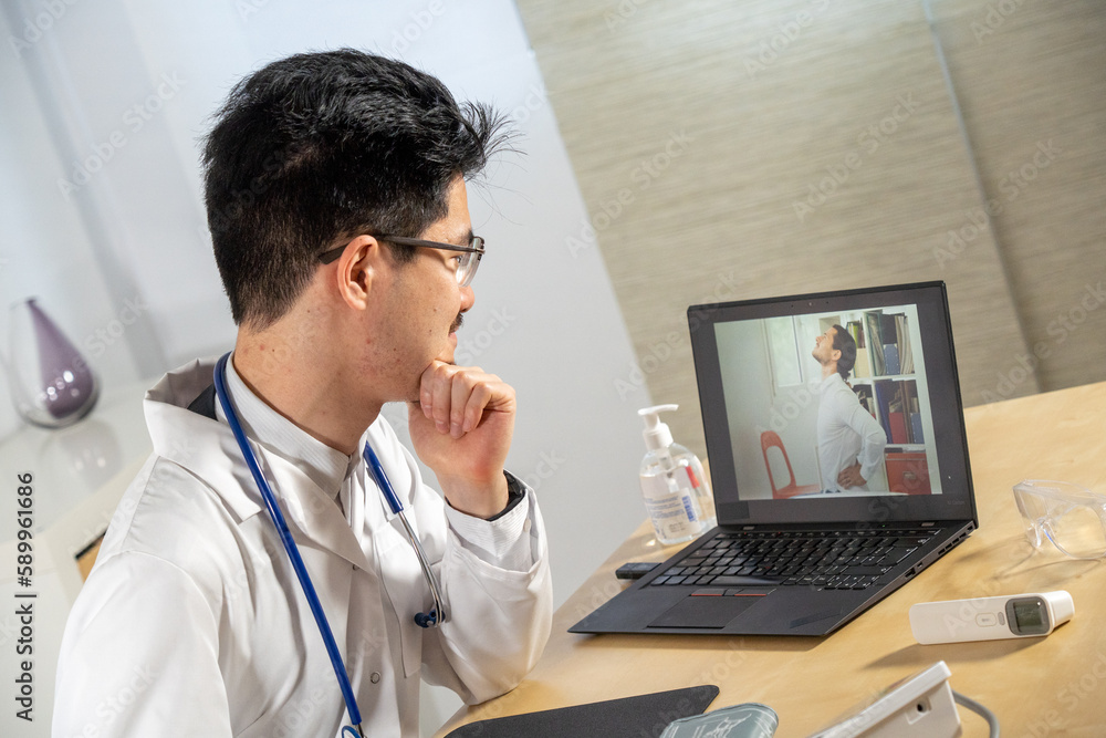 Doctor in remote consultation with 30 year old patient with back pain. Doctor in remote consultation with 30 year old patient with back pain.