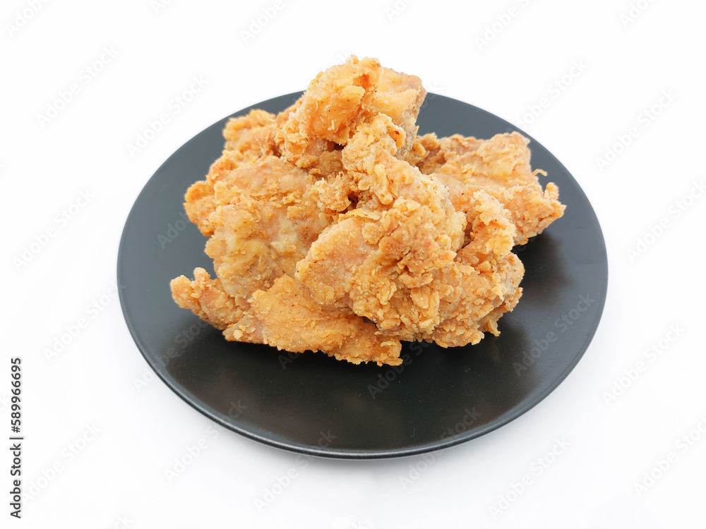 Heap of crispy fried chicken in a black plate isolated on white background. Selective focus. Heap of crispy fried chicken in a black plate isolated on white background. Selective focus.