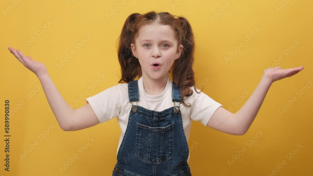 Portrait of excited amazed little girl kid looking shocked surprised wow showing hands brain explosion gesture, posing isolated over yellow color background wall in studio. People emotion concept Portrait of excited amazed little girl kid looking shocked surprised wow showing hands brain explosion gesture, posing isolated over yellow color background wall in studio. People emotion concept