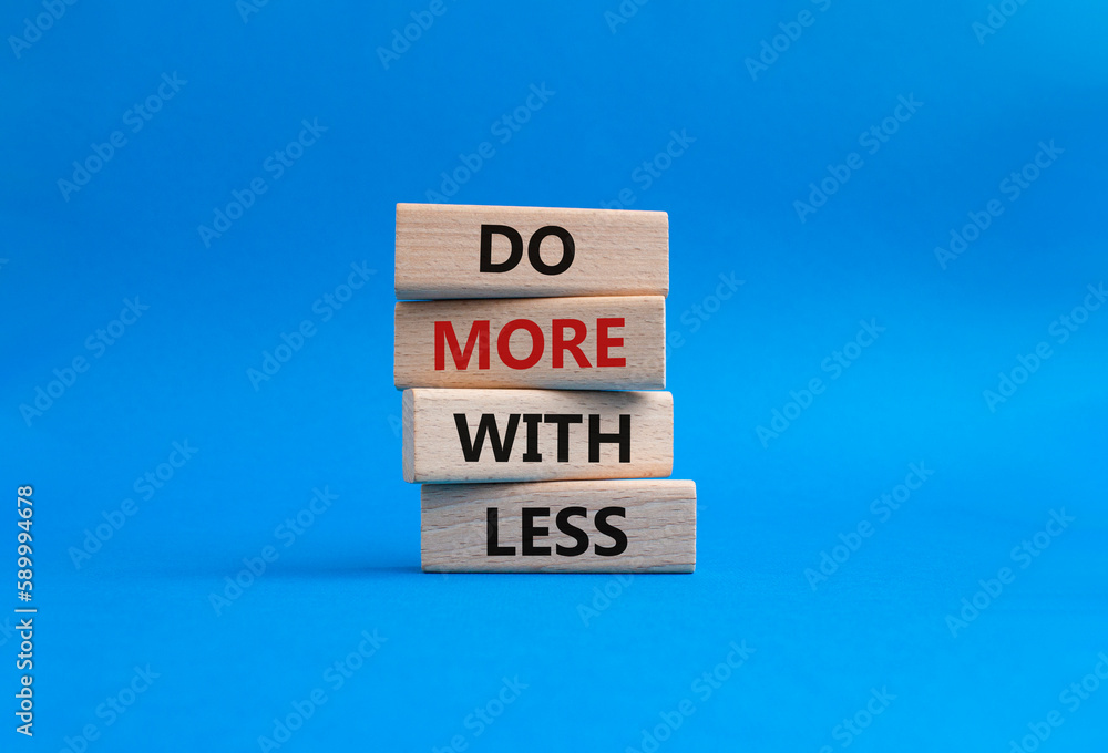 Do more with less symbol. Concept words Do more with less on wooden blocks. Beautiful blue background. Business and Do more with less concept. Copy space. Do more with less symbol. Concept words Do more with less on wooden blocks. Beautiful blue background. Business and Do more with less concept. Copy space.