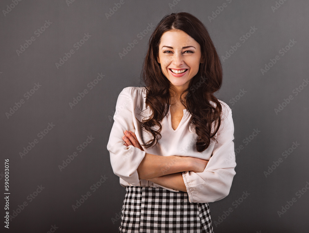 Beautiful business toothy enjoying laughing woman with long brown healthy curly hair style in white shirt clothing with folded arms. Closeup Beautiful business toothy enjoying laughing woman with long brown healthy curly hair style in white shirt clothing with folded arms. Closeup