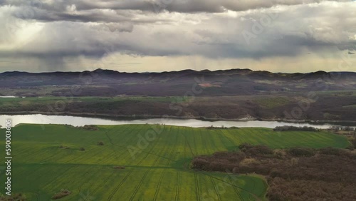 Flying over agricultural plains with rapeseed fields in early flowering around Trakiets Dam in Bulgaria, Europe.
 photo