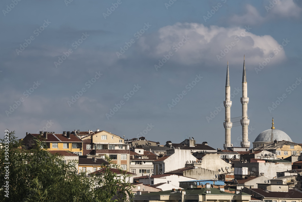 Istanbul city panorama with low rise buildings and mosque minaret, cloudy summer day