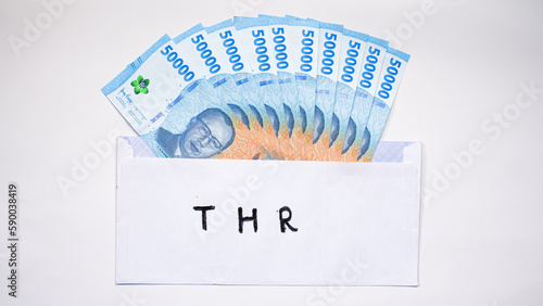 New edition of Indonesian banknotes in a white envelope for THR (tunjangan hari raya) and salary. photo