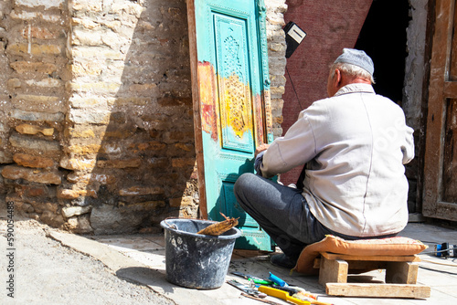 a man paints and repairs a wooden door. door fixing