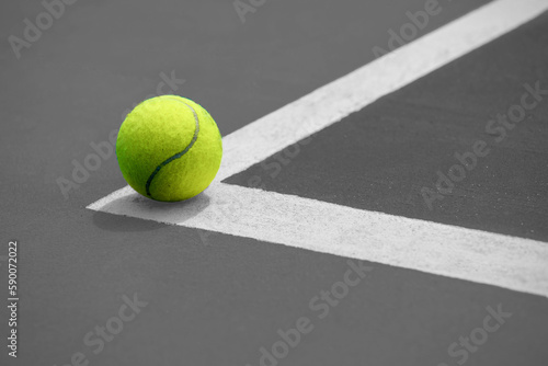 Tennis ball on the blue-coated cour