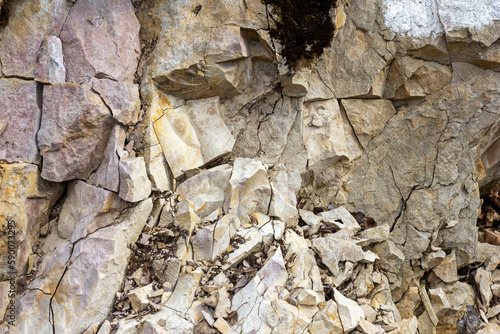 Natural stone walls are the entrance to a cave on a vertical rock of a mountain canyon. photo