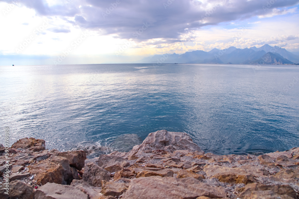 Mediterranean Sea and mountains peak in the distance seen from Antalya coast, Turkey